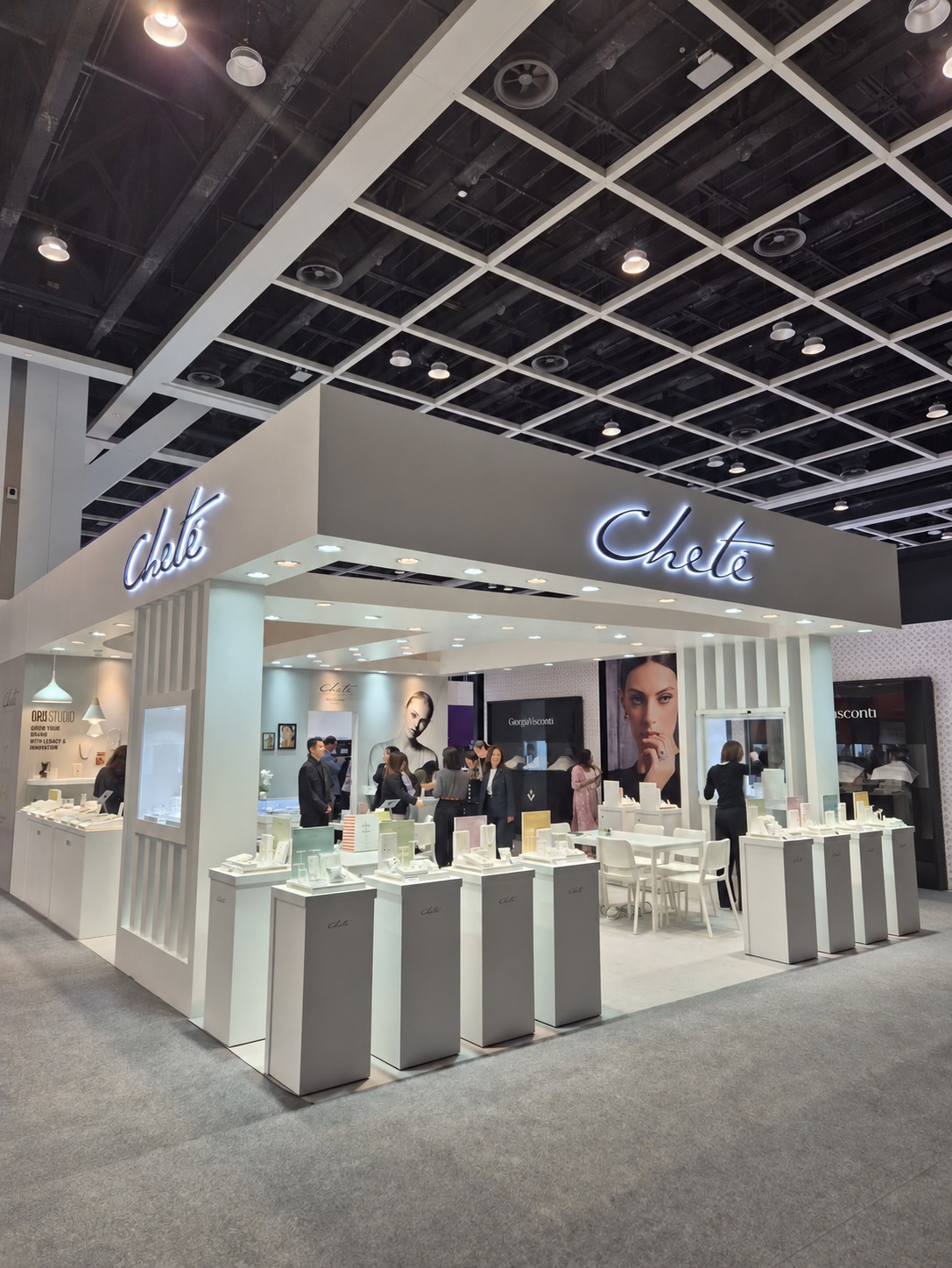 CHETE exhibition stand with jewellery displays and large campaign portraits.